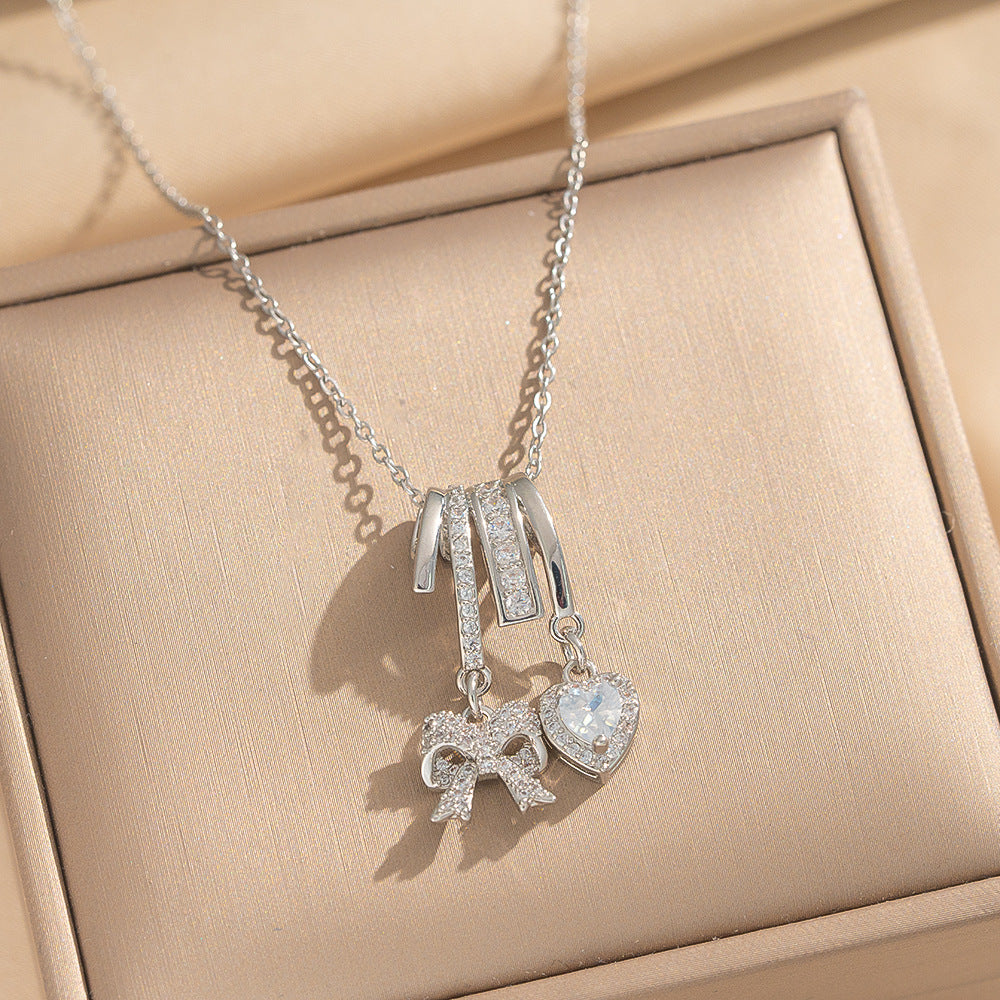 Collana Pendente Lusso Minimalista a Fiocco e Cuore in Acciaio al Titanio Placcato Oro su Catena a O per Unisex