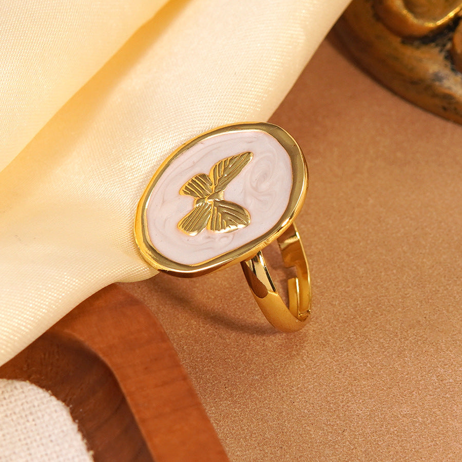 Anello Tondo in Acciaio Inossidabile con Farfalla Geometrica e Goccia Dolce