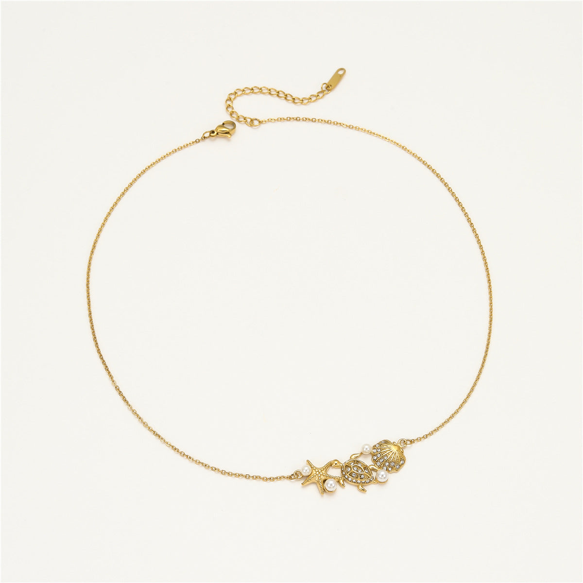 Collana con pendente a tema oceano a forma di stella marina e tartaruga da donna in acciaio inossidabile con intarsi in strass e conchiglia, finitura placcata, catena a clavicola delicata