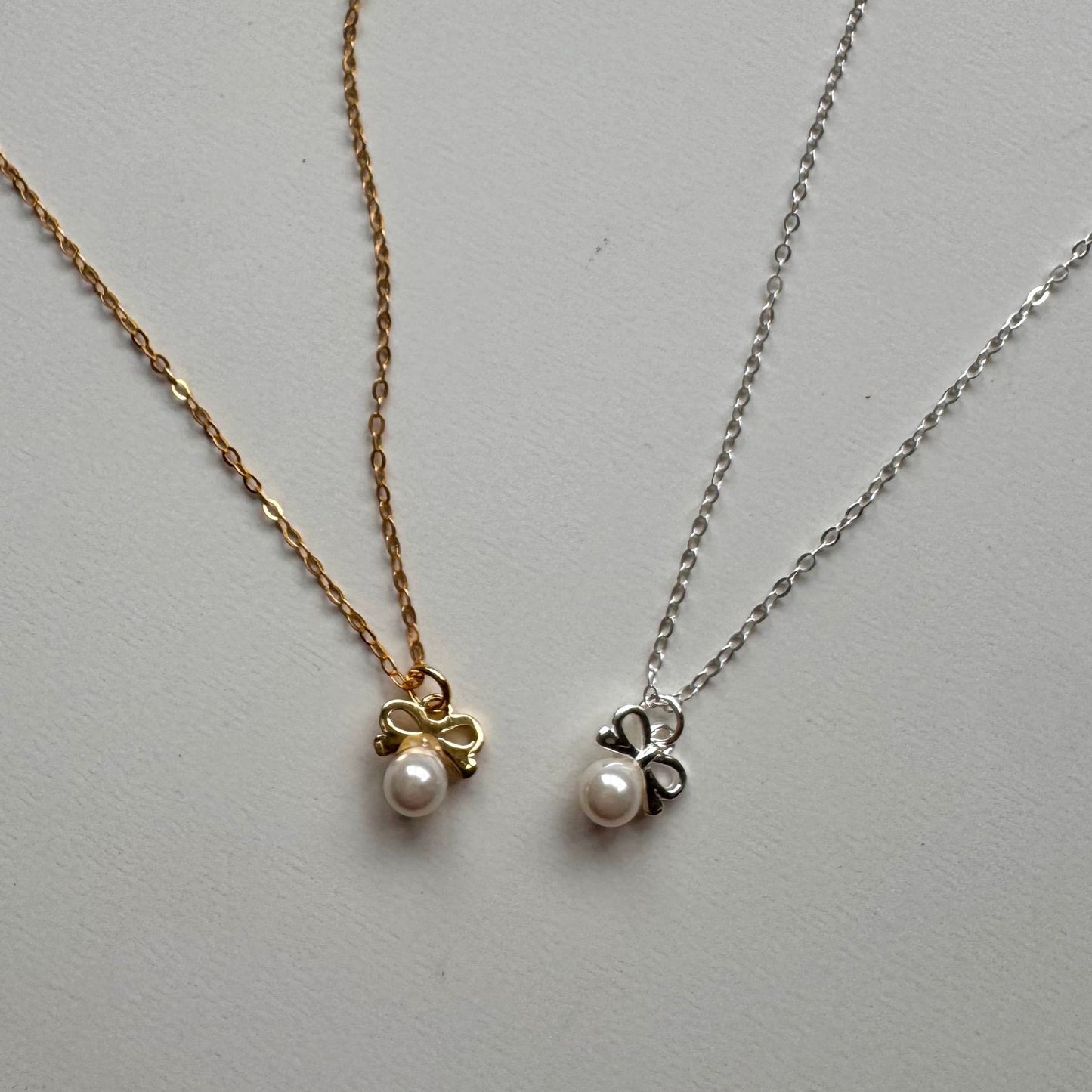 Minimalist Bow Knot Pendant Necklace in 925 Sterling Silver with Pearl Accents on Snake Chain