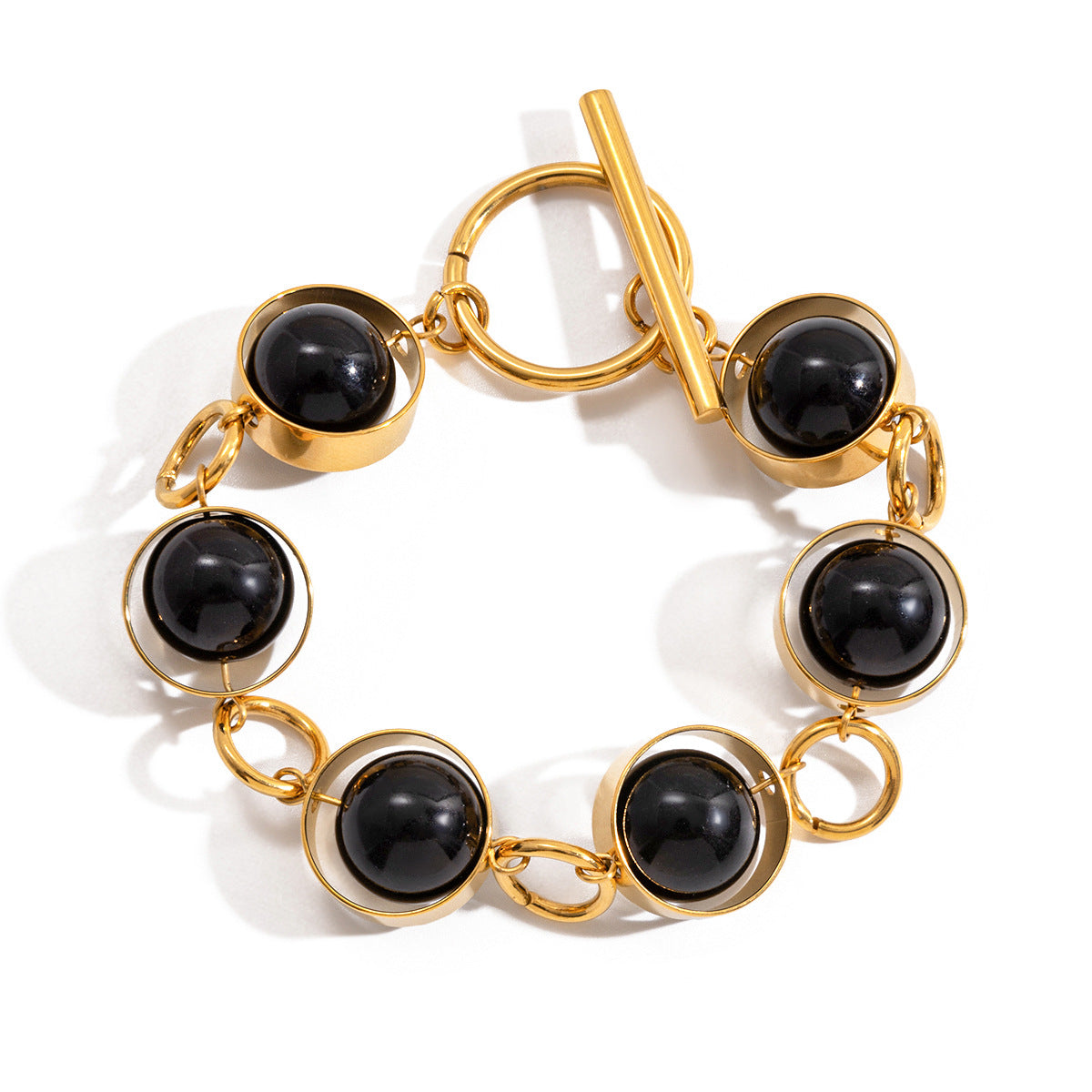 Bracciale minimalista geometrico girevole con chiusura a T in perline di vetro nero e acciaio al titanio con finitura placcata