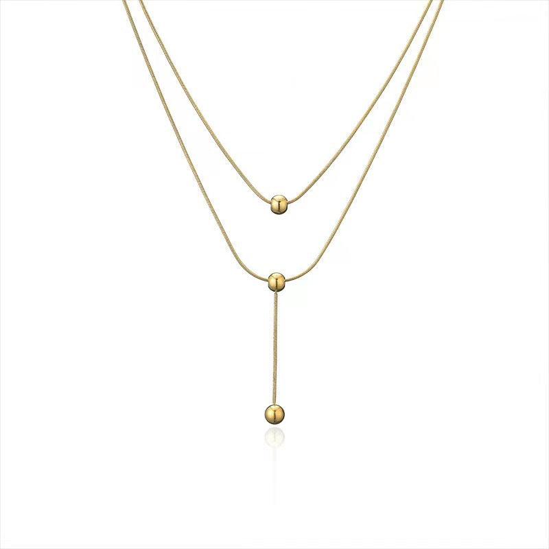 Collar minimalista de acero de titanio de dos capas con borla y cuentas redondas para mujer, estilo guardapelo con cadena de serpiente