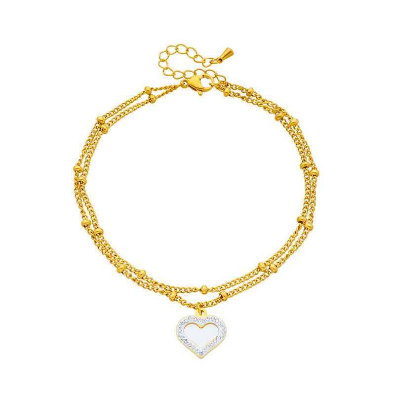 Cavigliera minimalista in acciaio al titanio a forma di cuore con intarsio di strass e design a doppia catena