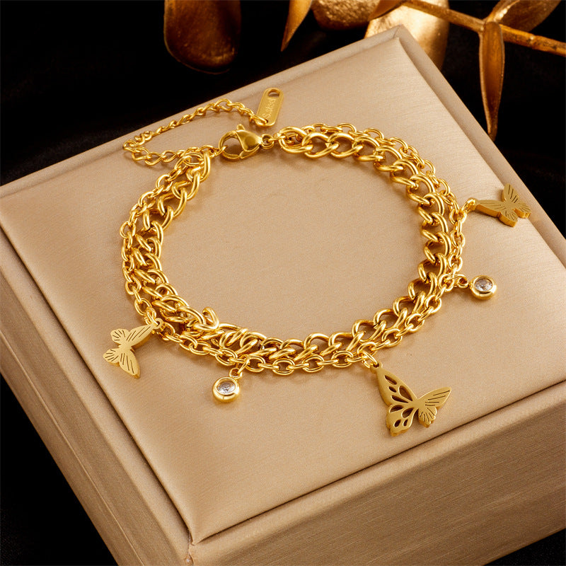 Pulsera de acero inoxidable chapada en oro con incrustaciones de pedrería, perlas y diseño floral de mariposa, elegante y minimalista, para mujer