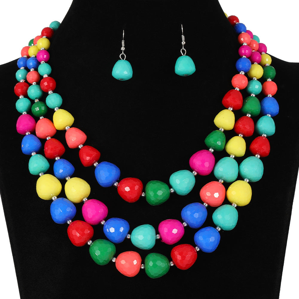 Conjunto étnico vintage de collar y pendientes de varias capas con cuentas y dijes de corazón en forma de campana con detalles de burbujas en resina plástica