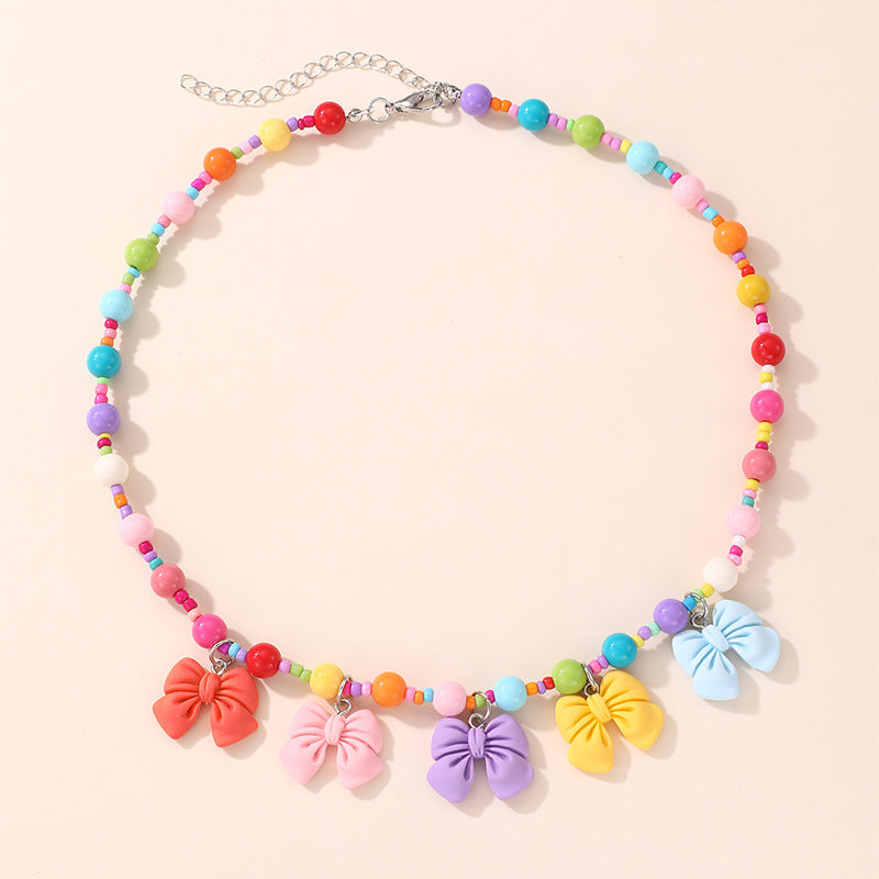 Collana con ciondolo a fiocco dolce pastello per ragazze con ciondolo in resina su catena a O, gioielli in stile cartone animato