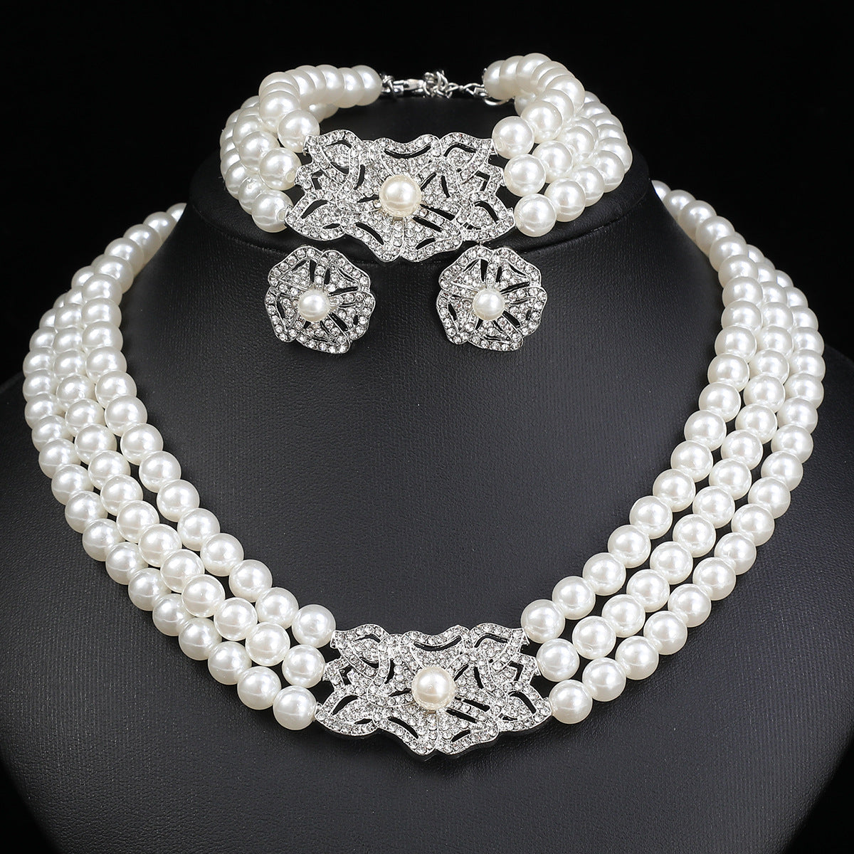 Parure di collana, bracciale e orecchini in perle con motivo floreale e strass, da donna