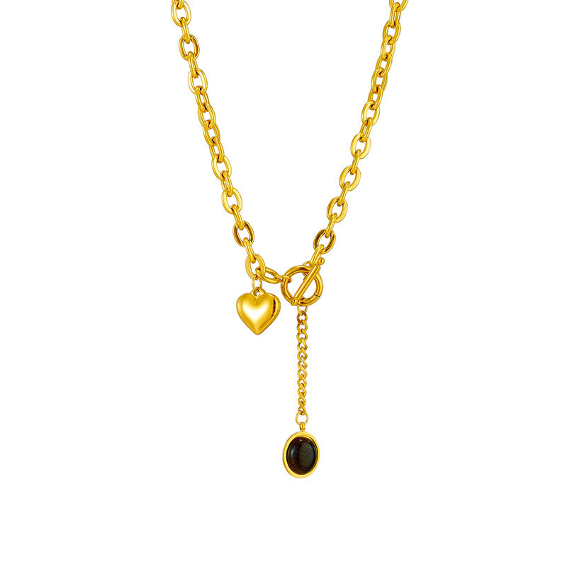Collana con ciondolo ovale minimalista in acciaio titanio con dettaglio nappa e chiusura OT a forma di cuore