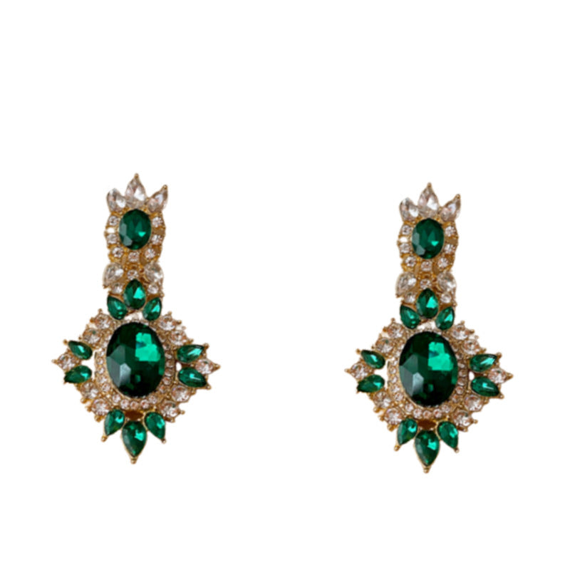 Orecchini ovali vintage in strass verde smeraldo con perni in metallo placcato e design geometrico da donna