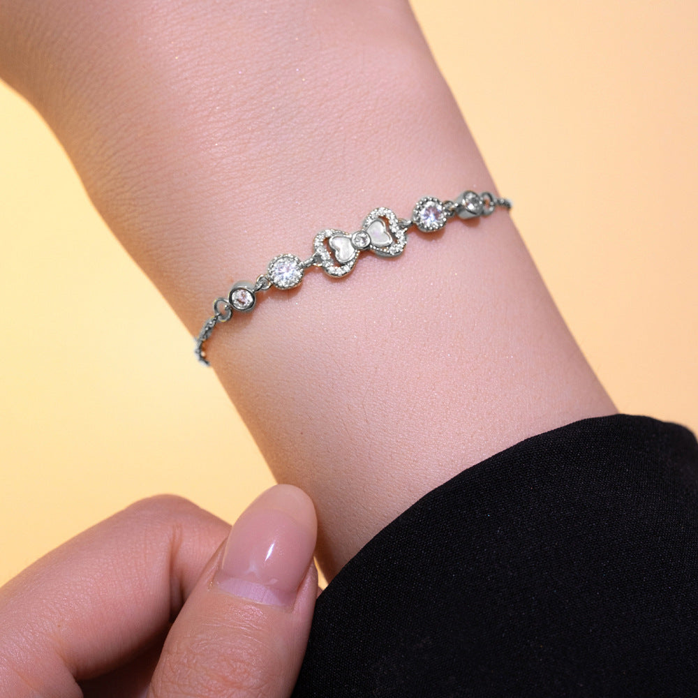 Elegant Butterfly Knot Shaped Titanium Steel Bracelet with Rhinestone Inlay and Gold Plating for Women