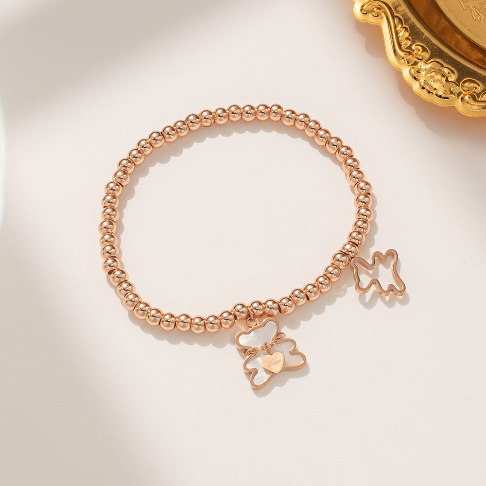 Bracciale Minimalista con Orsetto in Acciaio al Titanio, Perline, Intarsio in Madreperla e Placcatura in Oro per Donne