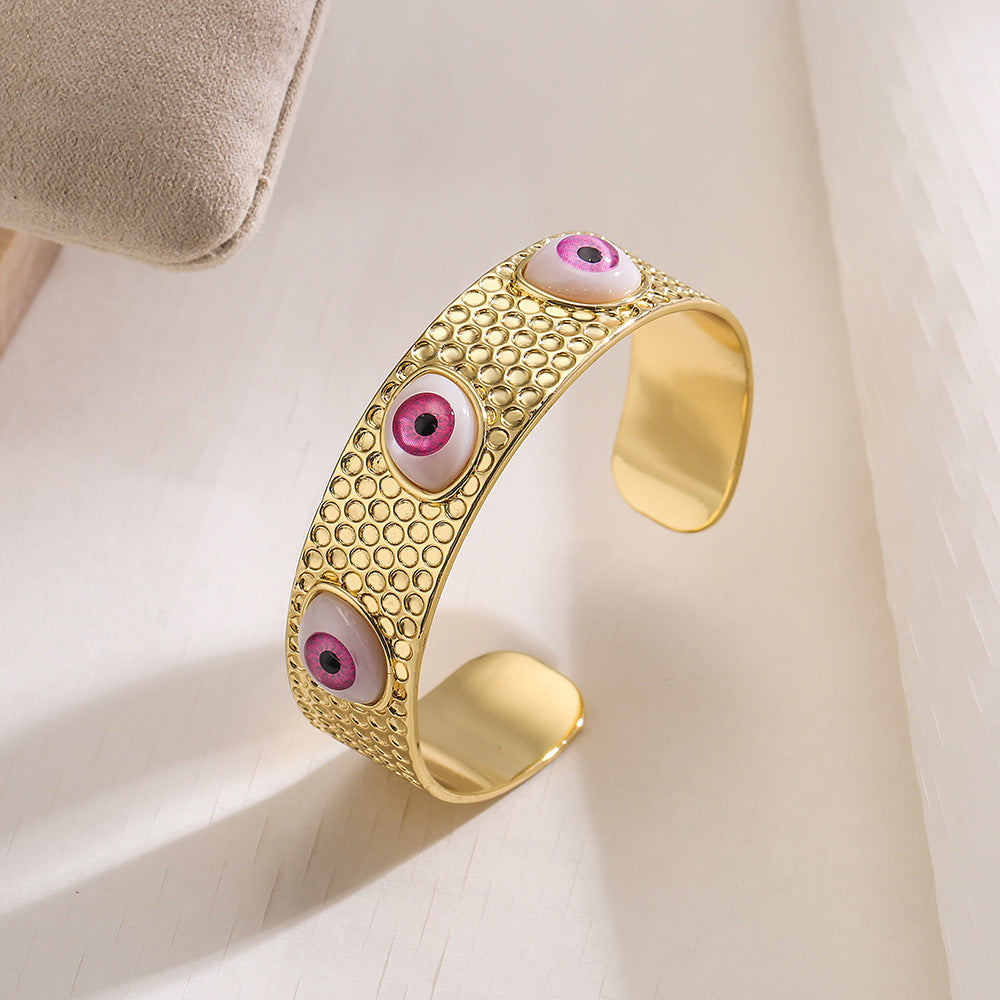 Bracciale rigido aperto geometrico da donna con base in rame e placcatura in oro 18 carati con design a occhio di Allah