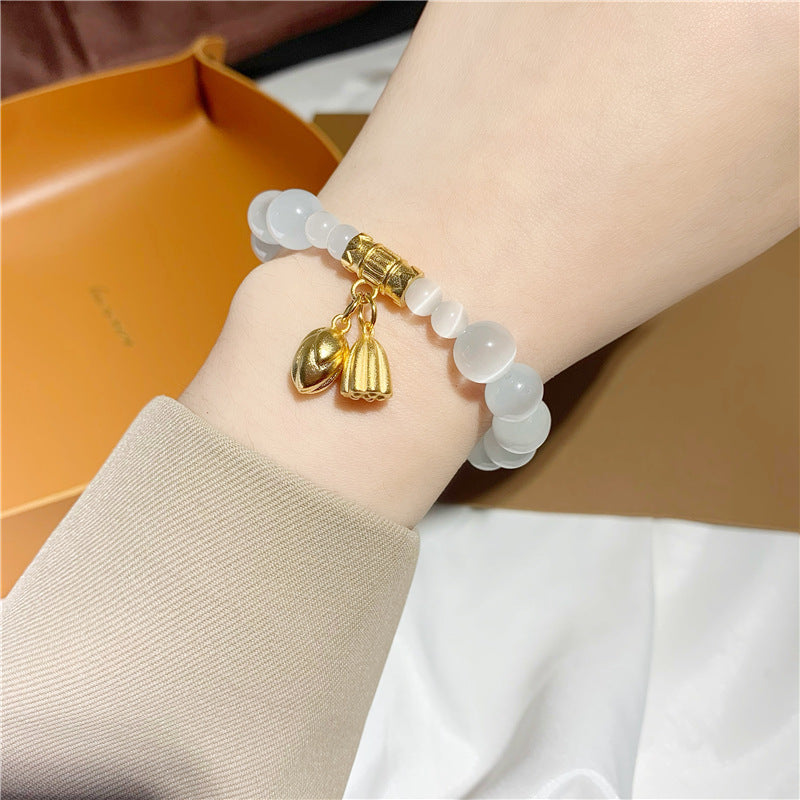 Bracciale da donna placcato in titanio e acciaio, con design floreale minimalista, pietra occhio di gatto e ciondolo portafortuna Fu