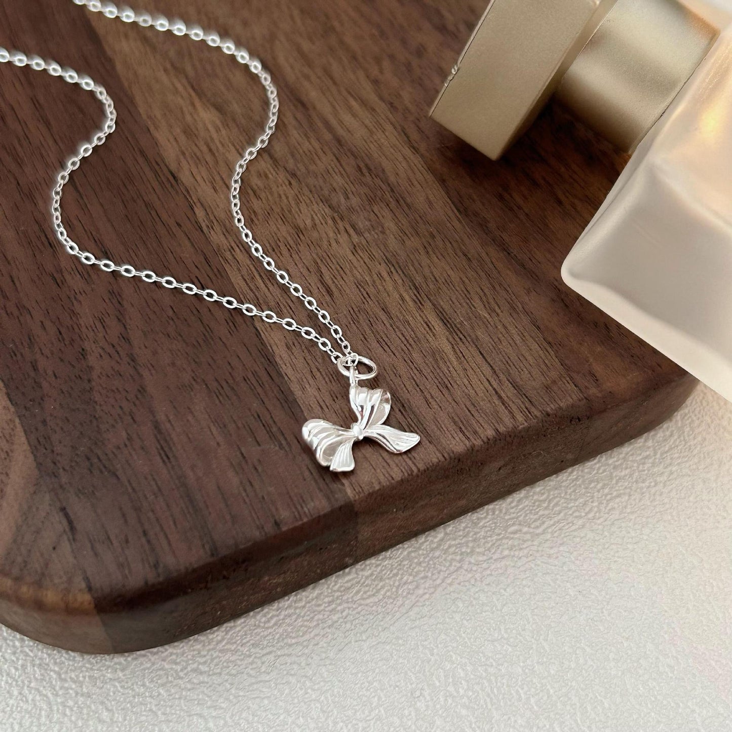 Minimalist Bow Knot Pendant Necklace in 925 Sterling Silver with Plated Finish on Cross Chain