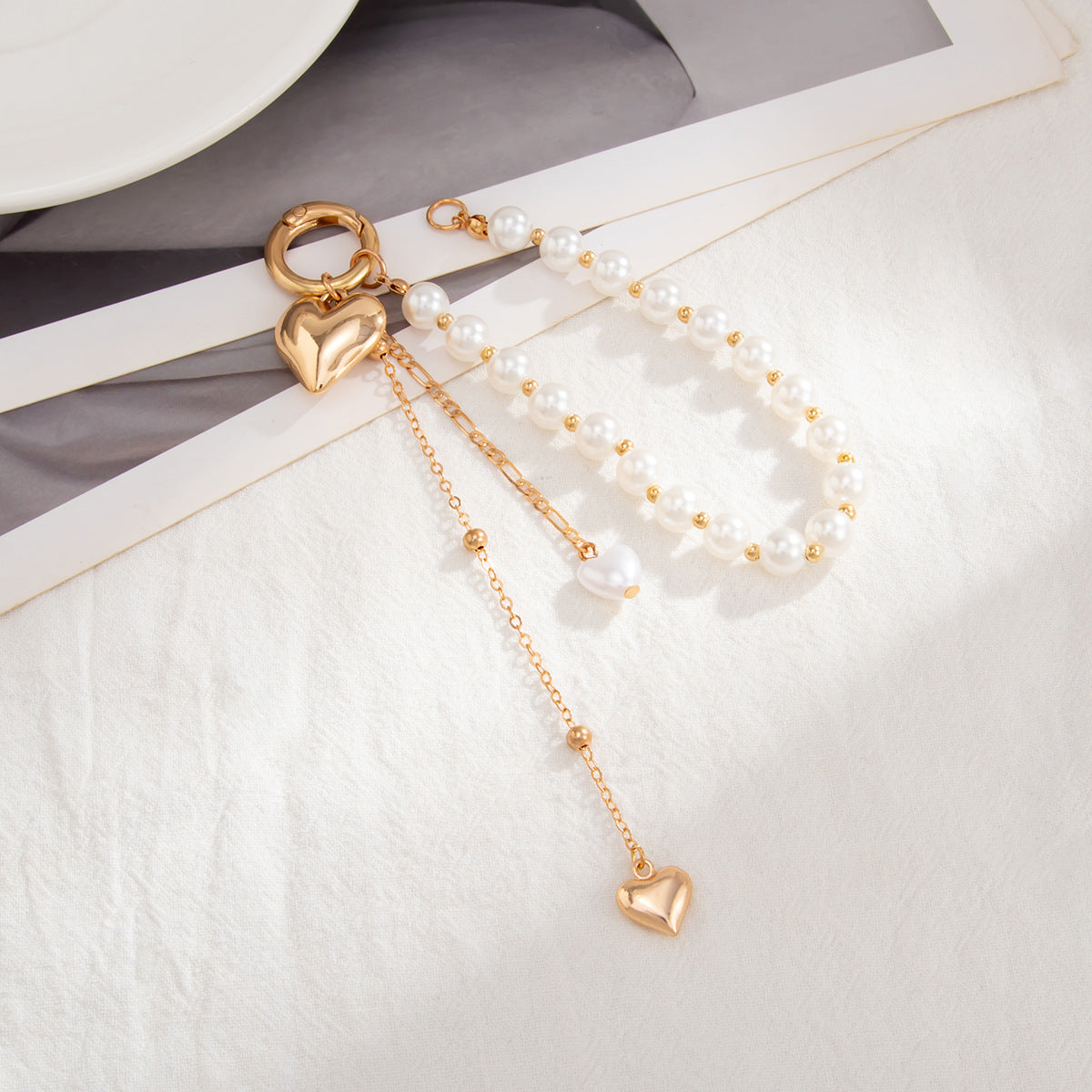 Minimalist Zinc Alloy Heart Pendant with Ceramic Pearl and Tassel Keychain Bag Charm