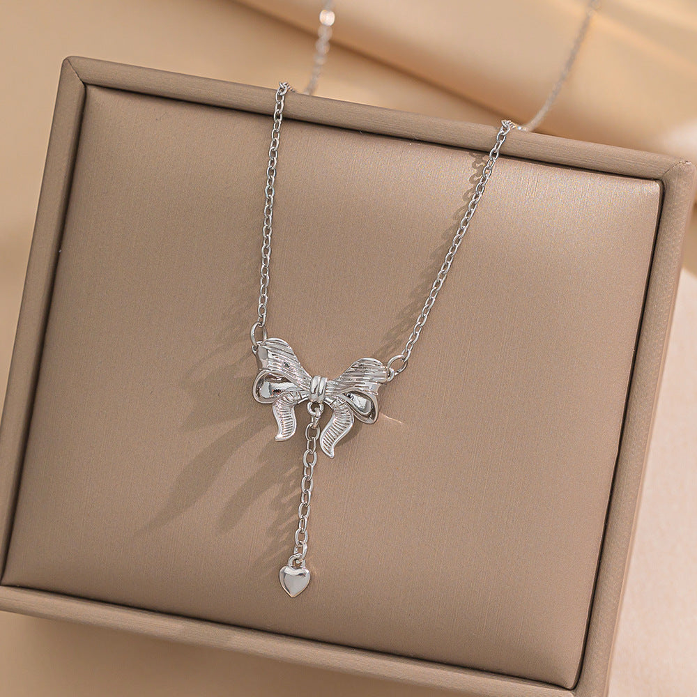 Minimalist Bowknot Tassel Heart Pendant Necklace in Titanium Steel with Vacuum Plating Snake Chain for Women
