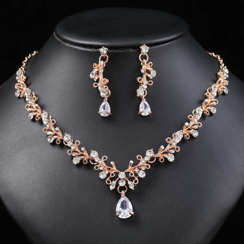 Set di collana e orecchini in lega dolce e fresca con ciondolo in cristallo a forma di campana a goccia a cuore, finitura placcata per donna