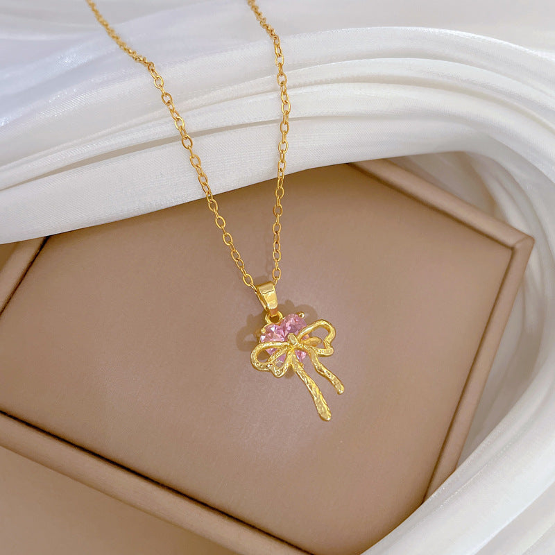 Collana con ciondolo a fiocco rosa con strass da donna in acciaio al titanio con catena a locket delicata