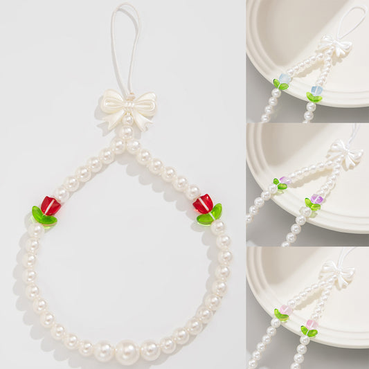 Bonita correa de teléfono con nudo de lazo de tulipán y perlas de imitación para mujeres, accesorio tejido a mano con dulce estilo floral