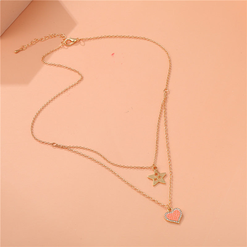 Elegante collana a forma di cuore e stella in lega per bambini con finitura smaltata e design a catena incrociata multistrato