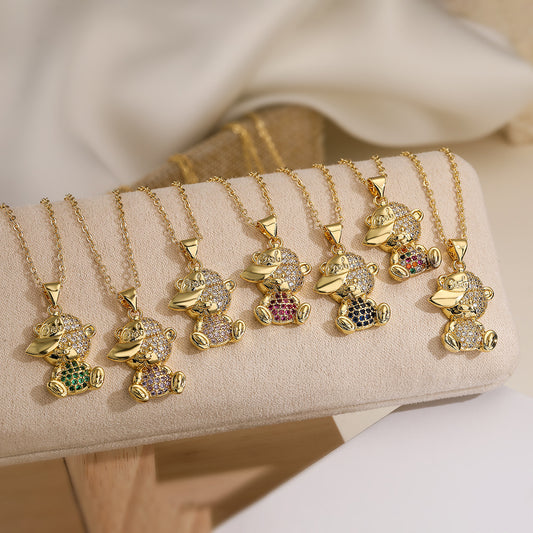 Collar con colgante de cobre chapado en oro con forma de oso minimalista para mujer con detalles de pedrería y cadena a la altura de la clavícula