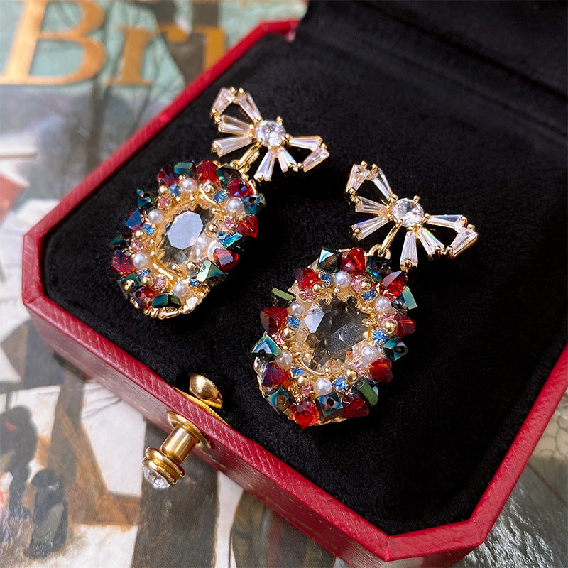 Elegantes pendientes de perlas y circonitas con forma ovalada y lazo en acero inoxidable para mujer