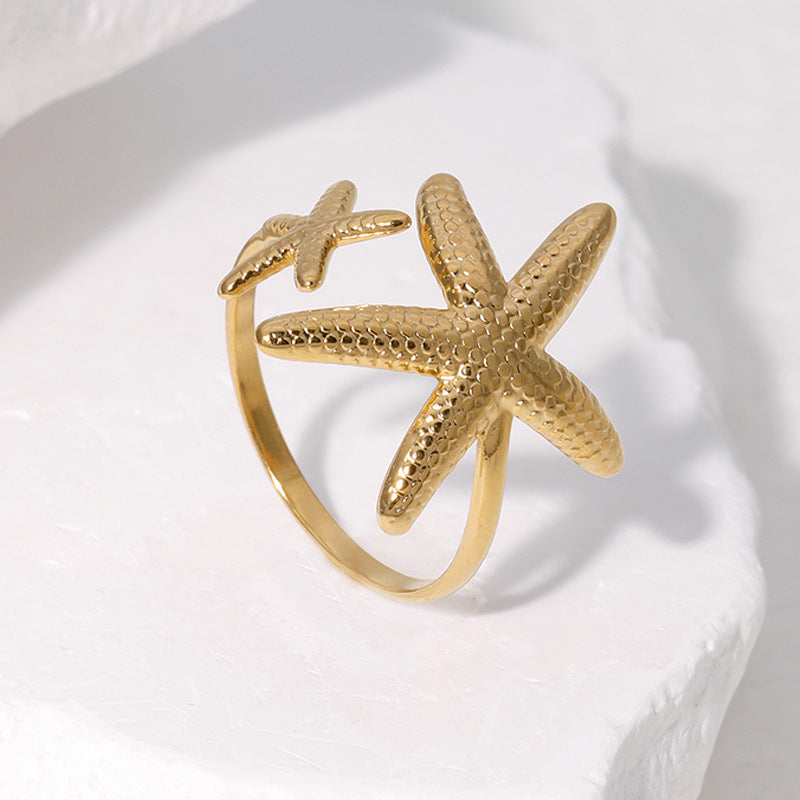 Elegante anello regolabile da donna in acciaio inossidabile a forma di stella marina con finitura placcata, gioiello da spiaggia ispirato all'oceano