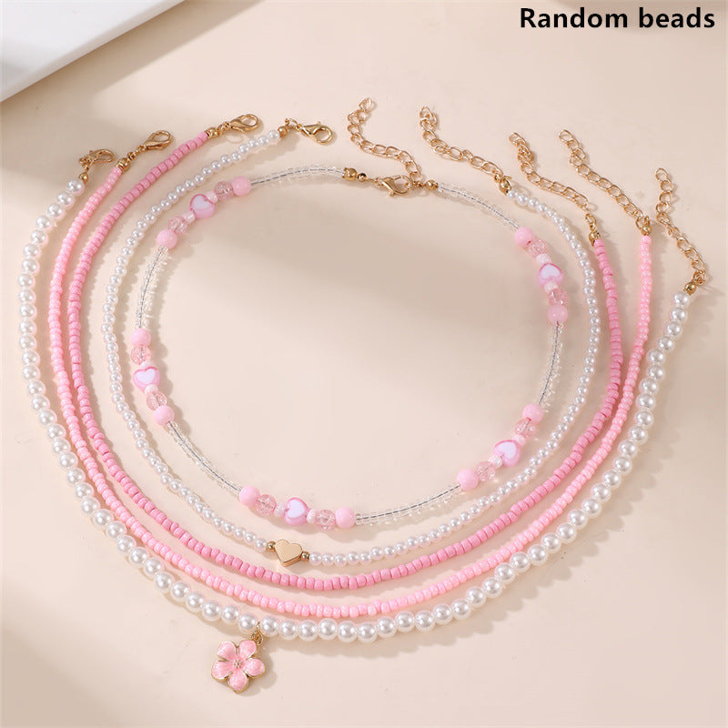 Collar Minimalista de Corazón de Concha Marina y Perla para Niñas con Dije de Resina y Acabado Pulido en Cadena de Cuentas