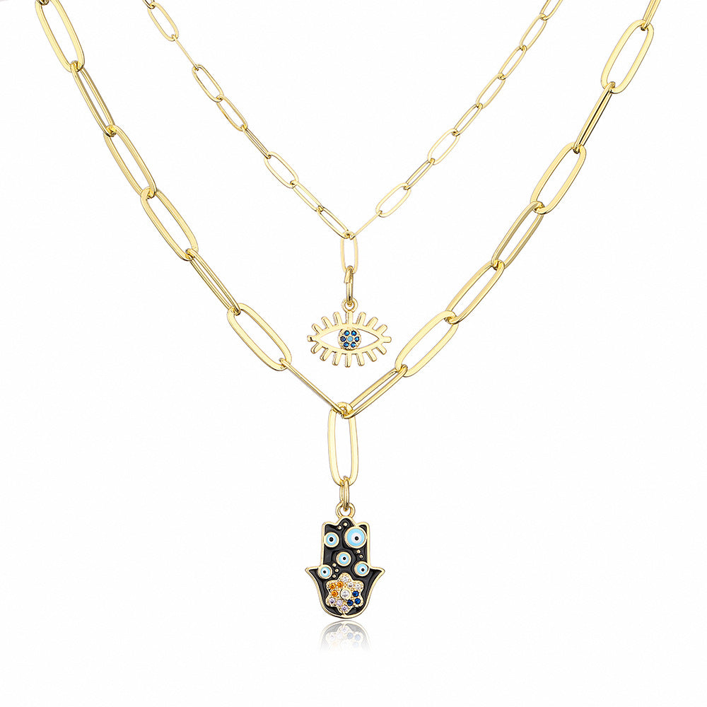 Collana con ciondolo minimalista a mano e occhio per donna in rame con finitura smaltata e intarsi in strass su catena placcata oro 18 carati