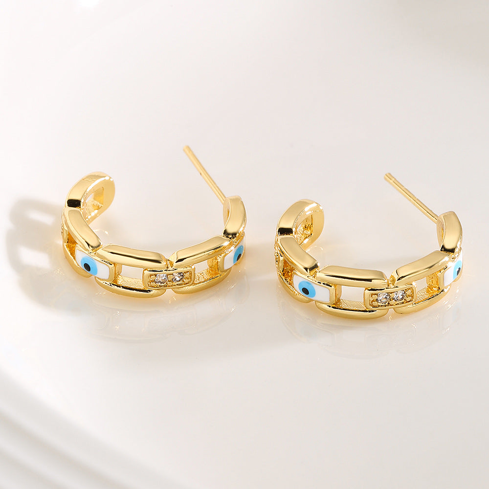 Orecchini geometrici in rame placcato oro con smalto a forma di occhio per donna