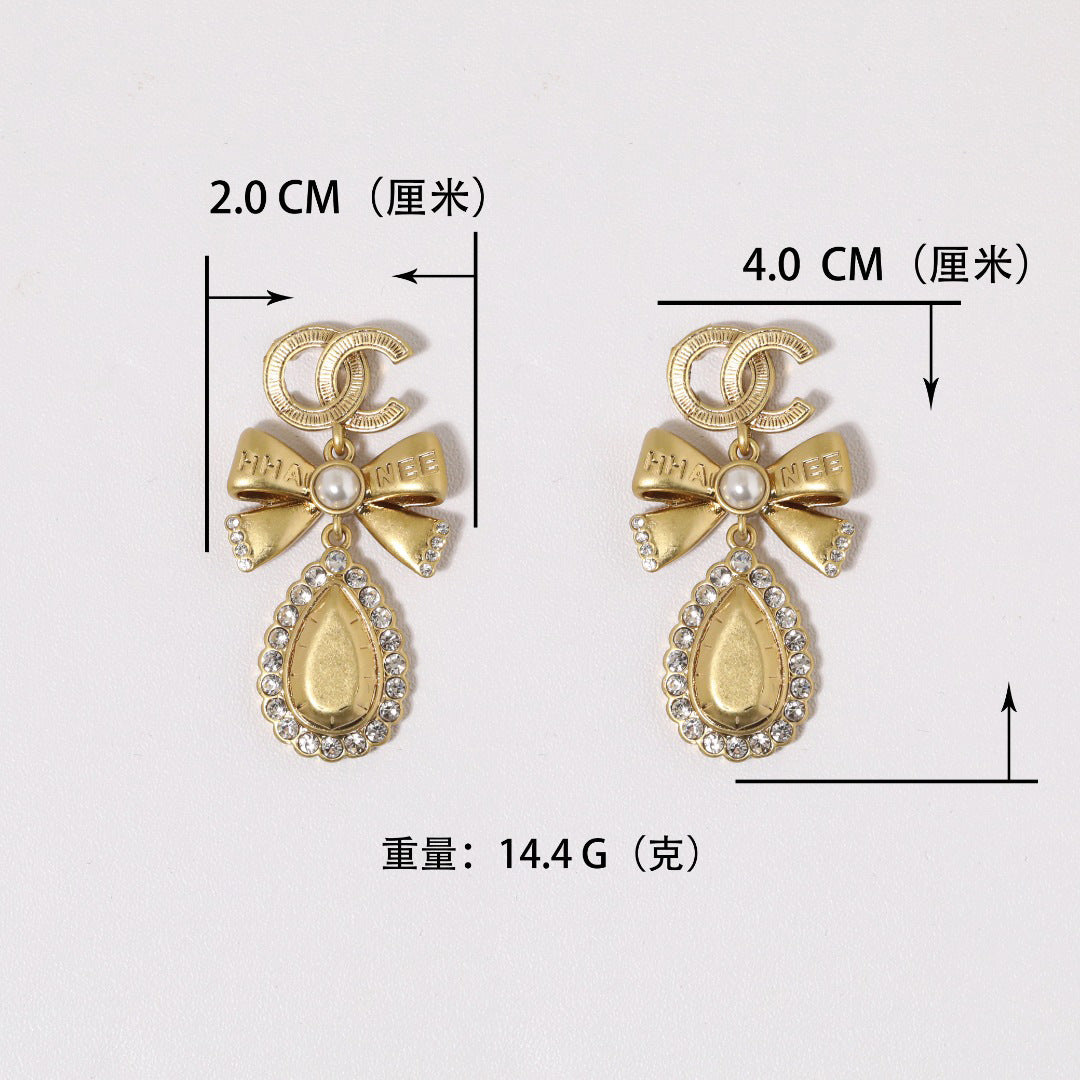 Orecchini vintage in ottone placcato oro con fiocco e strass, perno in argento sterling 925