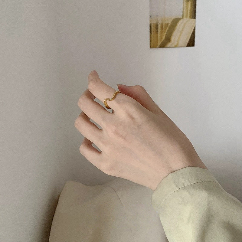 Anillo minimalista de acero de titanio geométrico de línea ondulada para mujer con acabado galvanizado y diseño de contorno irregular