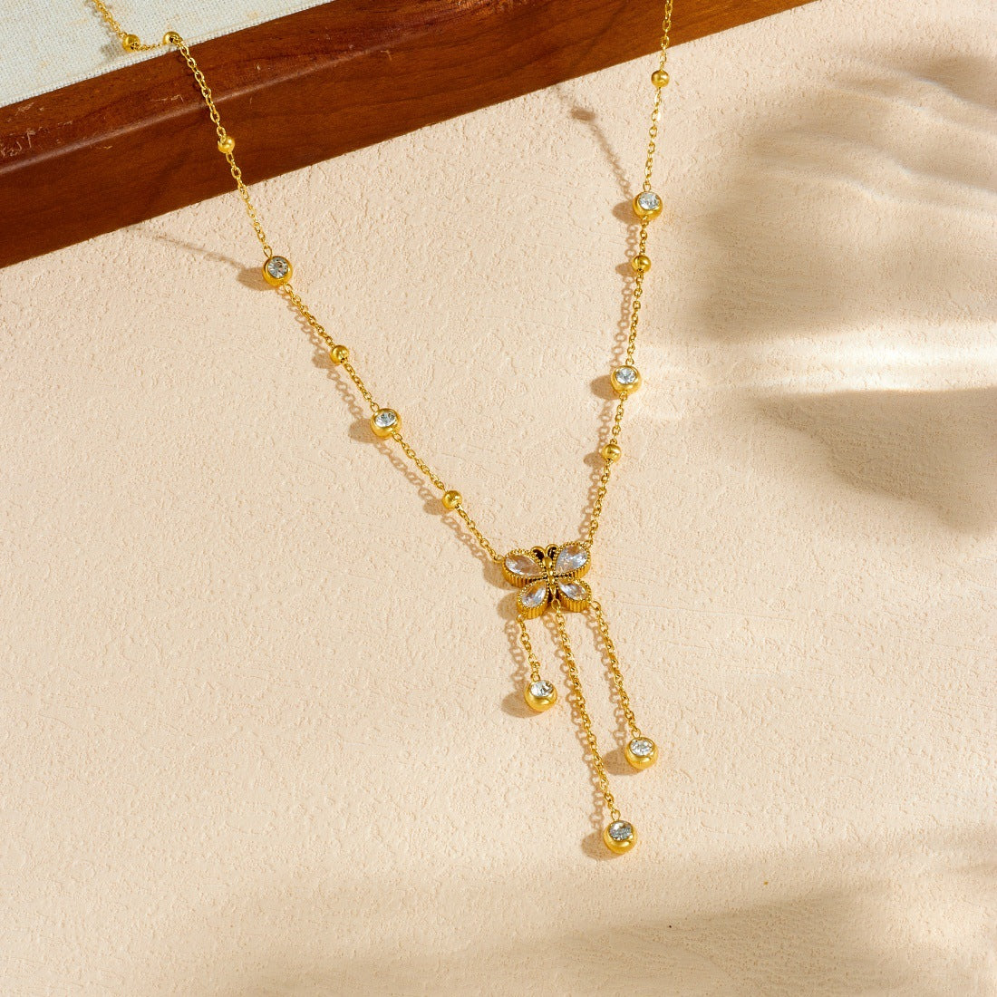 Minimalist Gold Plated Stainless Steel Butterfly Teardrop Pendant Necklace with Rhinestone Inlay and Tassel Chain for Women