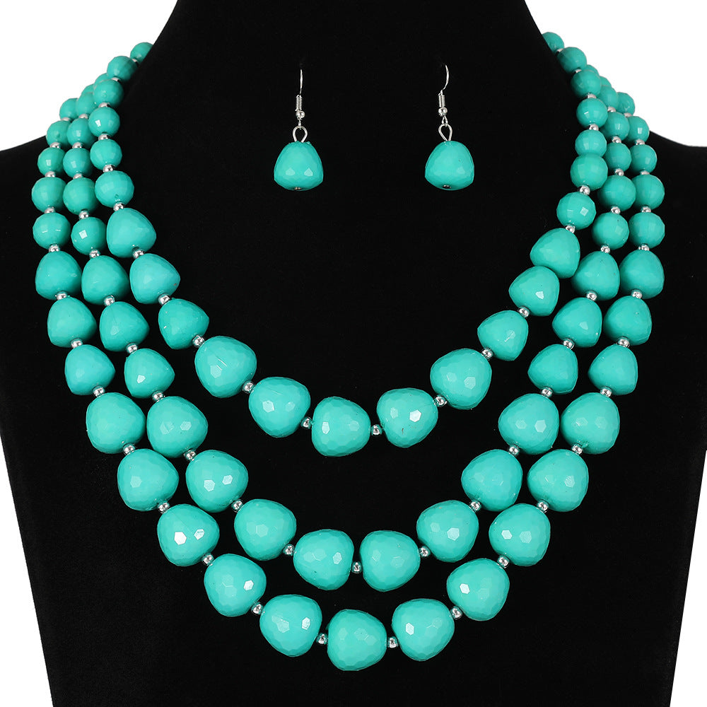 Conjunto étnico vintage de collar y pendientes de varias capas con cuentas y dijes de corazón en forma de campana con detalles de burbujas en resina plástica