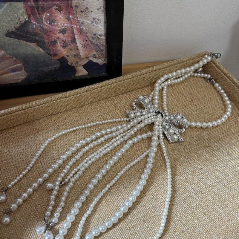 Elegante collar con colgante de lazo de diamantes de imitación de estilo francés en aleación con detalles de perlas de imitación, delicada cadena para la clavícula para mujer