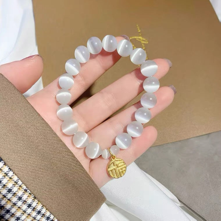 Bracciale da donna placcato in titanio e acciaio, con design floreale minimalista, pietra occhio di gatto e ciondolo portafortuna Fu