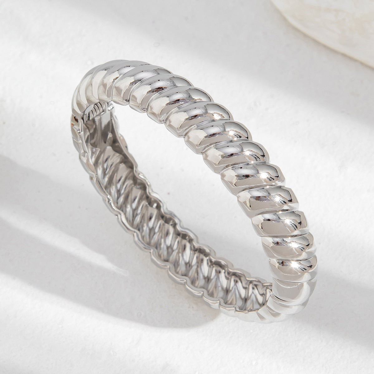 Bracciale minimalista in lega geometrica con finitura lucida e chiusura a molla con texture filettata