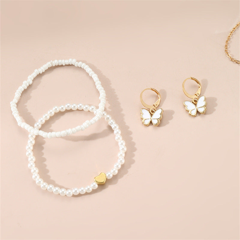 Set collana con ciondolo a farfalla fatto a mano per bambini con perline bianche e ciondolo in lega in stile fresco