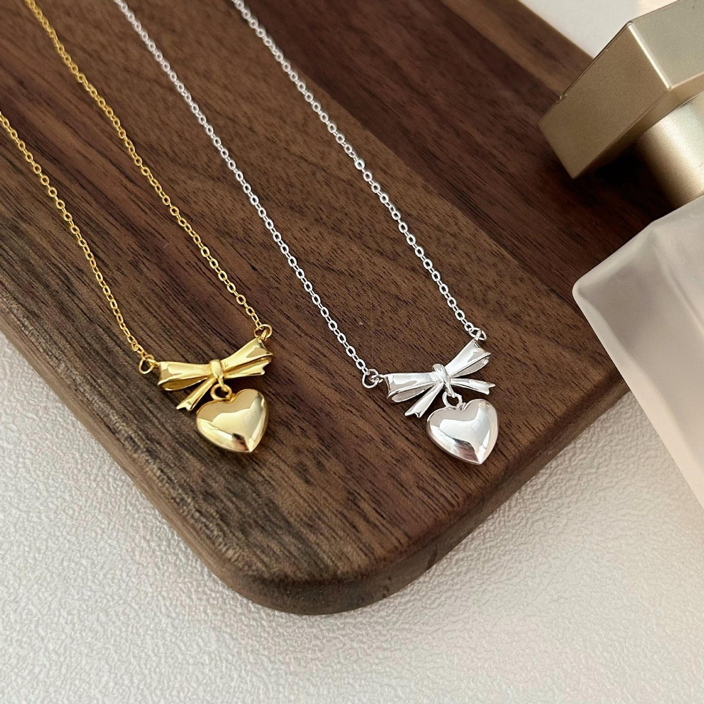 Minimalist Heart and Bow Pendant Necklace in 925 Sterling Silver with Gold Plating on Cross Chain
