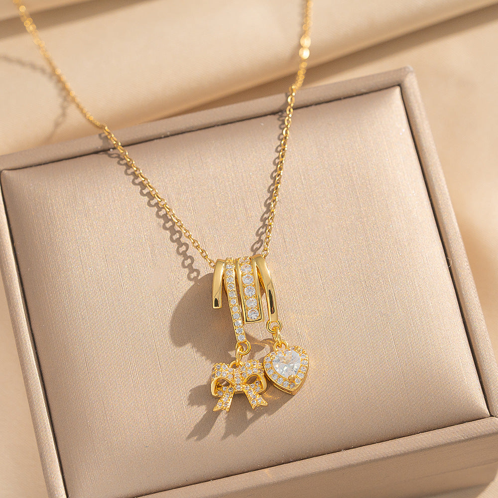 Collana Pendente Lusso Minimalista a Fiocco e Cuore in Acciaio al Titanio Placcato Oro su Catena a O per Unisex