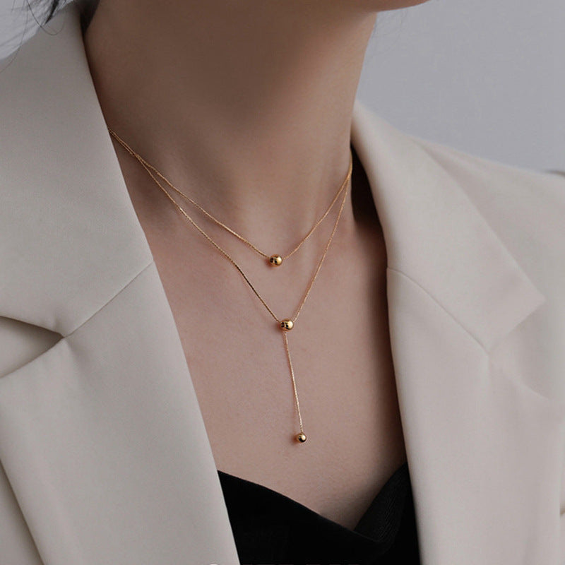 Collar minimalista de acero de titanio de dos capas con borla y cuentas redondas para mujer, estilo guardapelo con cadena de serpiente