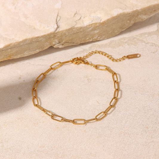 Cavigliera Minimalista Geometrica in Acciaio al Titanio con Catena a Spillo in Oro 18K da Donna