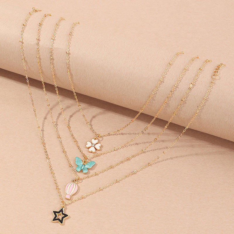 Set Collana per Bambini con Ciondoli a Cartone Animato Farfalla Stella Quadrifoglio Mongolfiera in Lega Smalto con Catena a Scatola