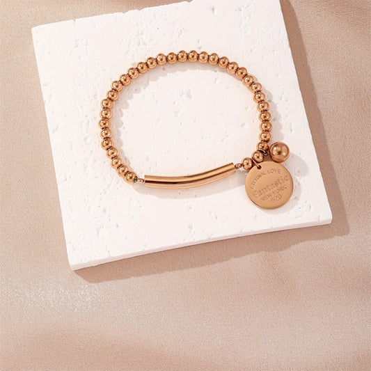 Pulsera minimalista de acero inoxidable con disco redondo para mujer con cuentas elásticas y acabado pulido