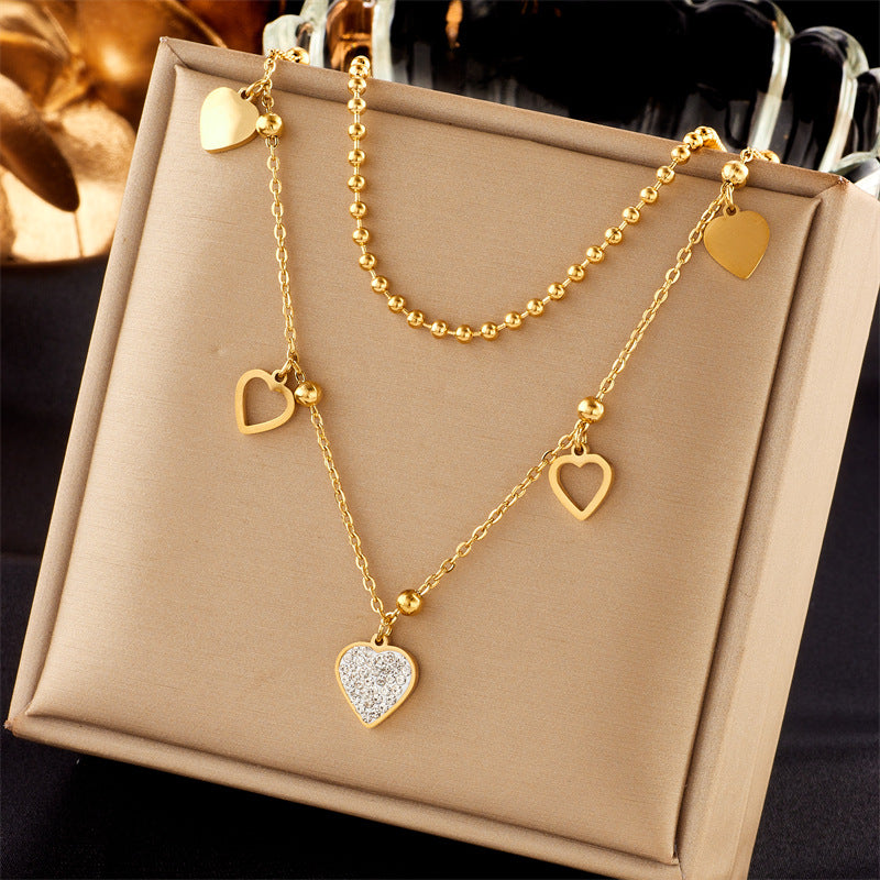 Collana con ciondolo a cuore doppio strato minimalista in acciaio al titanio con intarsio in strass e finitura placcata da donna