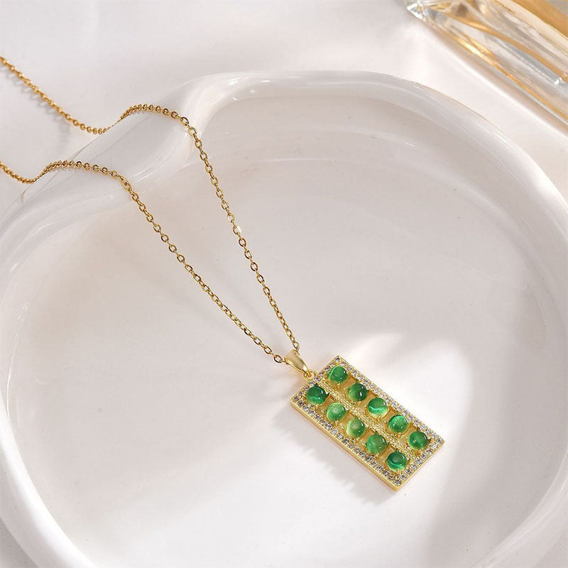 Collana con ciondolo floreale dal design originale per donne e uomini in acciaio al titanio con intarsio in rame placcato oro e catena a O