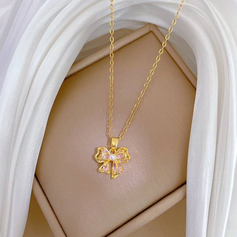 Collana con ciondolo a fiocco rosa con strass da donna in acciaio al titanio con delicata catena a medaglione
