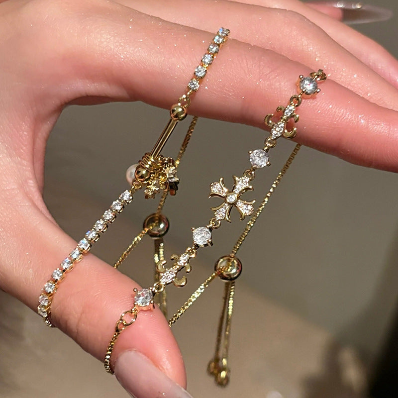 Bracciale a croce elegante a forma di Iris con zirconi intarsiati in rame, regolabile, da donna, lusso minimalista, floreale
