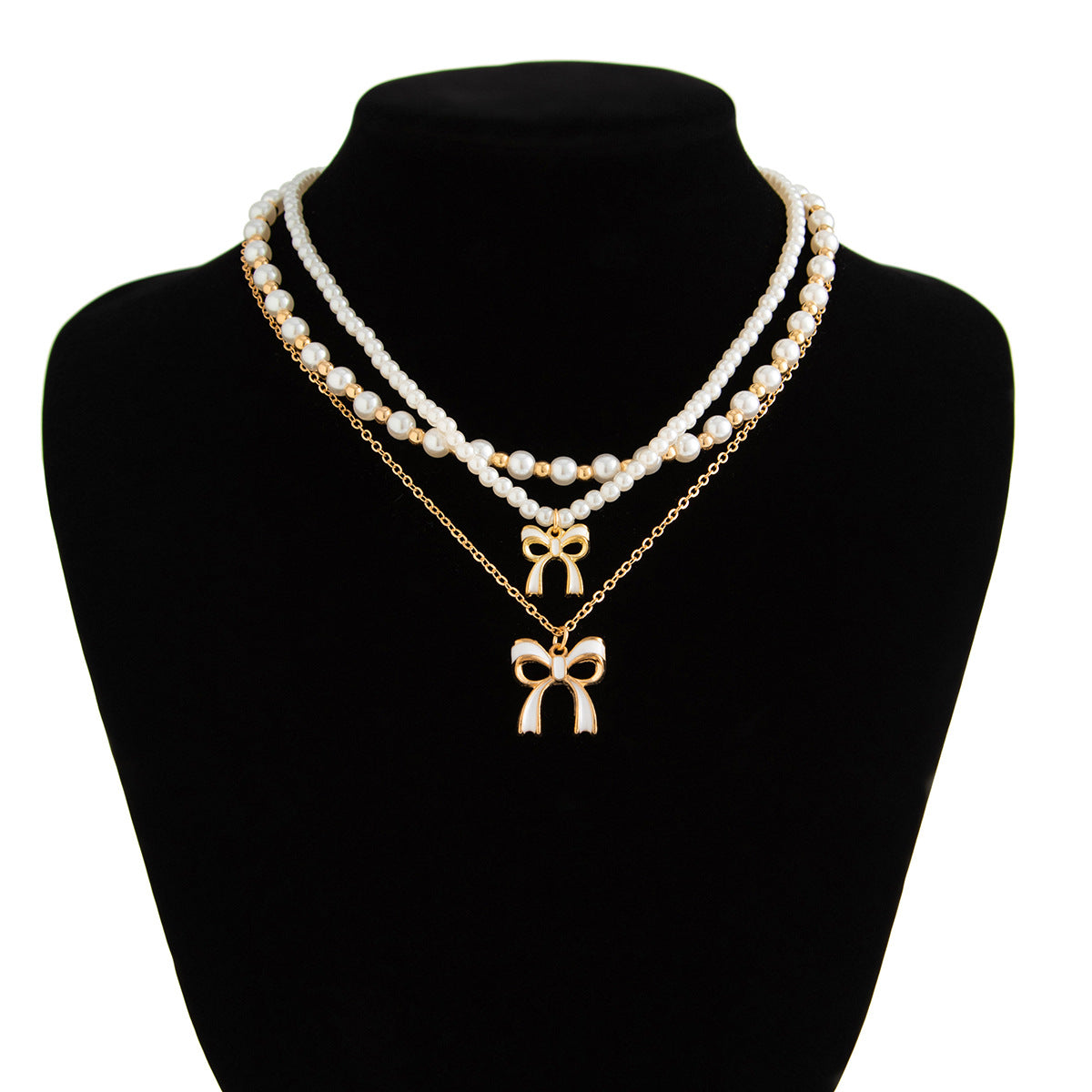 Graziosa collana pendente a forma di fiocco con dettaglio nappa, perla sintetica e lega, finitura placcata, stile a strati da donna