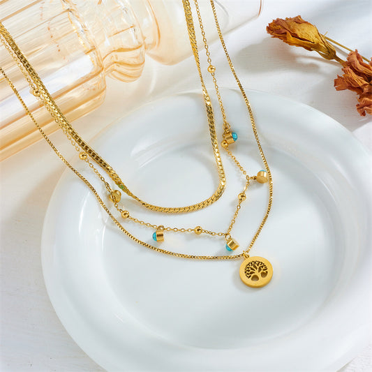 Collana pendente con albero della vita in stile minimalista in acciaio al titanio con intarsio in turchese su catena a clavicola multistrato